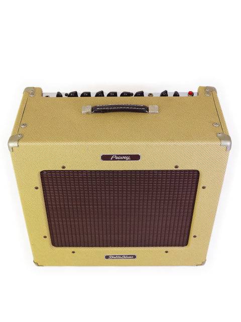 A yellow Peavey Delta Blues 115 Tweed guitar amp displayed against a white background, highlighting its classic look.