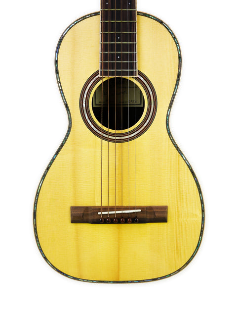 A yellow acoustic guitar rests against a white background, showcasing its vibrant color and sleek design. Gilet Bay State, Australia 2018.