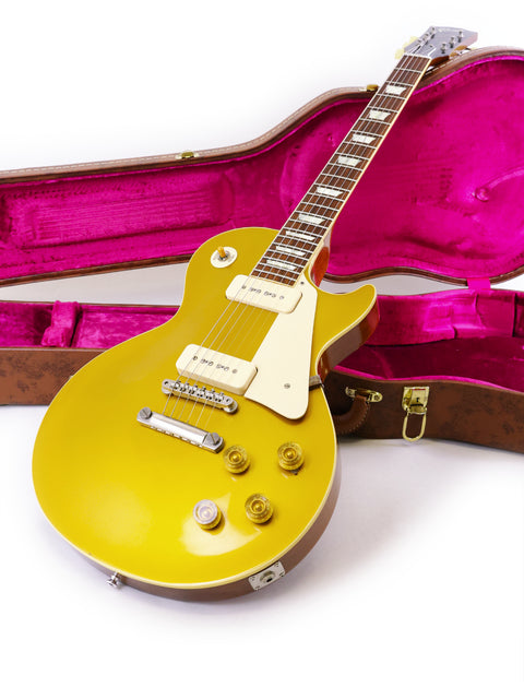A yellow guitar inside a pink case, featuring the Gibson Custom Historic VOS LPR-6 1956 Reissue Gold Top from the USA, 2014.