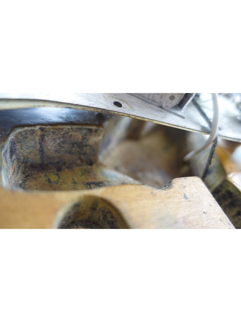 Aged metal with rust, featuring a close-up of a vintage 1963 L Series Stratocaster part, revealing its unique texture.