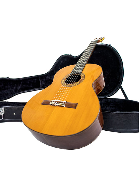 An Alhambra C-Series ORO classical guitar from Spain, resting in its case on a white background, highlighting its craftsmanship.