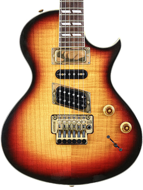 An electric guitar with a sunburst finish, the Gibson Nighthawk from 1997, showcasing its vibrant colors and sleek design.