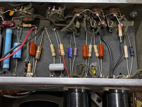 An old 1952 Fender Tweed 5B3 Deluxe, displaying a vintage electronic device surrounded by a mess of wires.