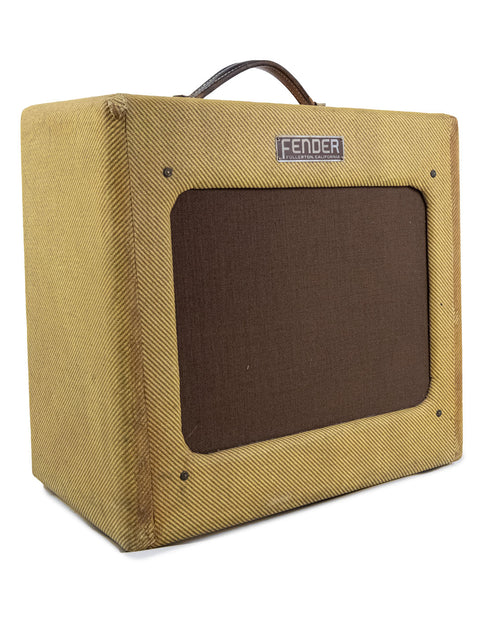 An old Fender Tweed 5B3 Deluxe amplifier from 1952, wrapped in a rich brown cover, representing classic music history.