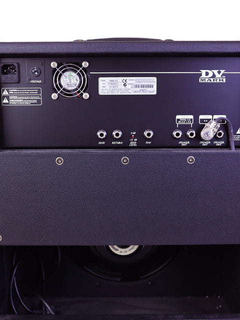 Back of a DV Mark guitar amplifier showing various input/output jacks and a cooling fan.