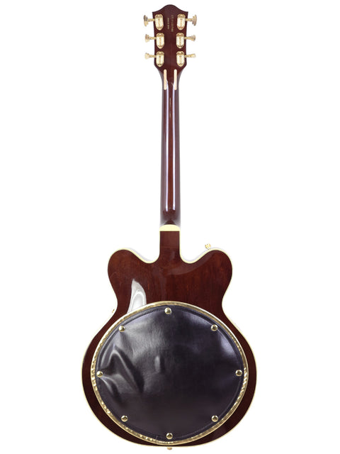 Beautiful Gretsch 6122T Chet Atkins guitar featuring a warm brown body and elegant black leather back, ideal for any music lover.