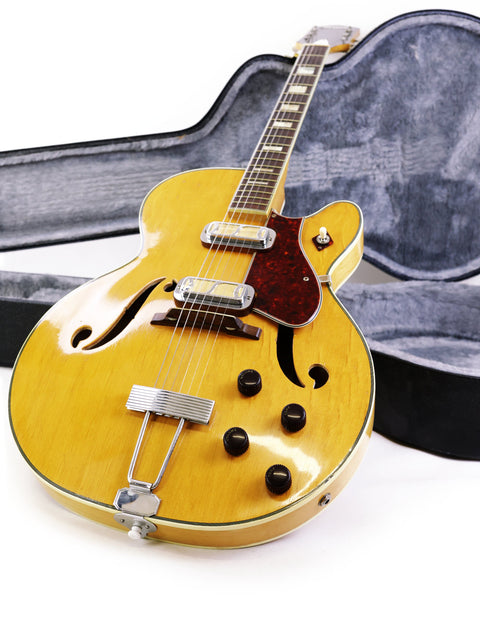 Beautiful yellow guitar, Harmony H71 Meteor from 1960-61, resting in a case, perfect for musicians and vintage guitar fans.