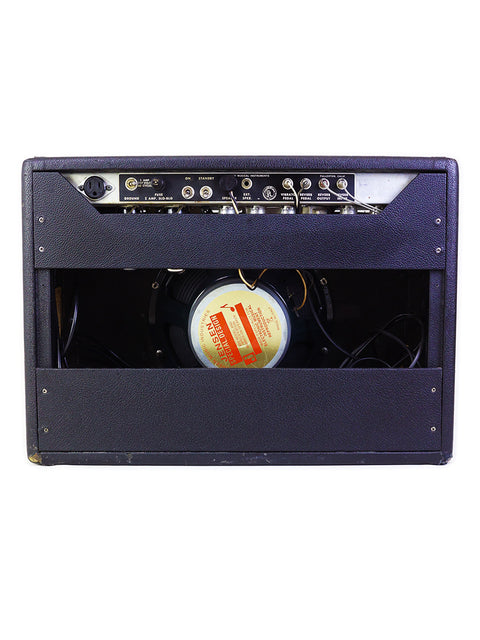 Black 1967 Fender Deluxe Reverb amplifier with a striking red and white label, delivering 22 watts of vintage sound.