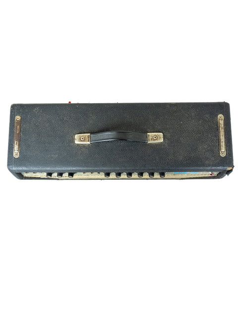 Black Fender Vibrolux Reverb Amp, model year 1977, presented on a white background, emphasizing its retro aesthetic.