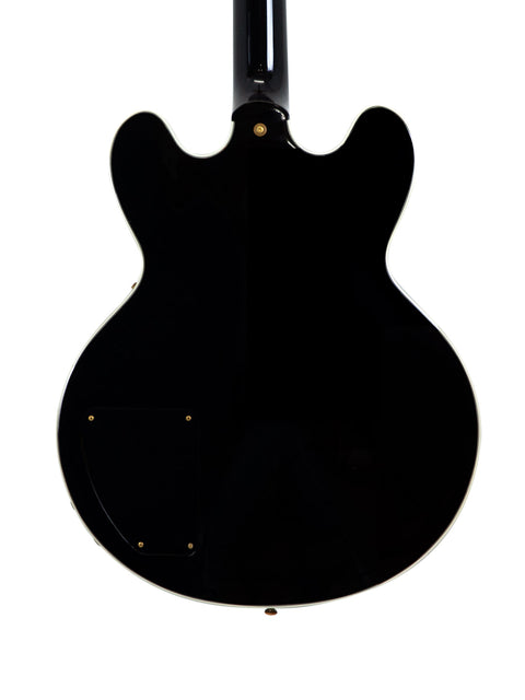 Black Gibson Lucille guitar featuring a white pickguard, autographed by BB King and Eric Clapton, made in the USA, 2000.