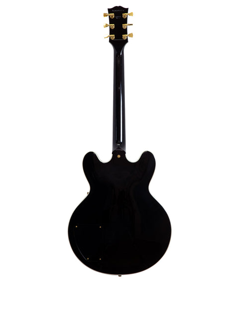 Black Gibson Lucille guitar on a white backdrop, featuring signatures of BB King and Eric Clapton, USA 2000.