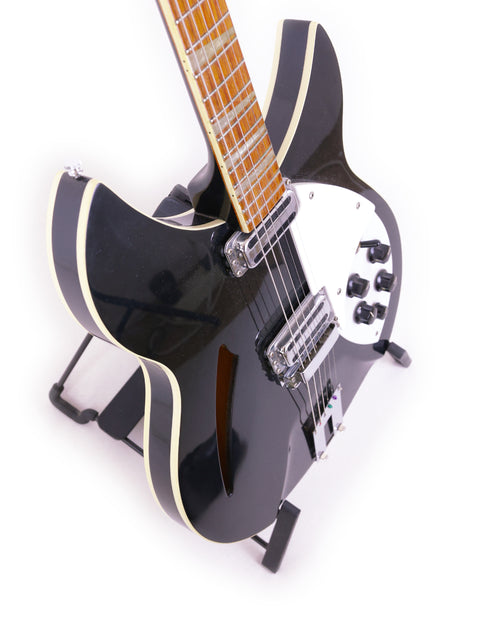 Black Rickenbacker 360 WB electric guitar with a white pick guard, USA model from 1996, showcasing its sleek design.