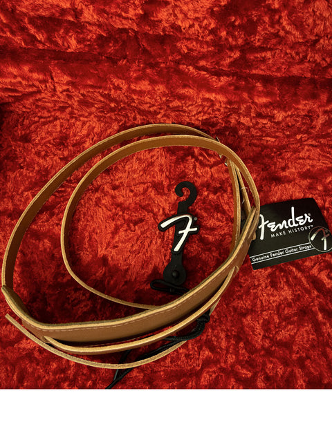Black and white logo adorns a Fender guitar strap, celebrating the 50th Anniversary of the 1954 Stratocaster model.
