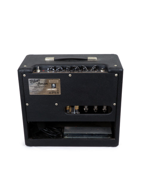 Black guitar amplifier with knobs and inputs, on a white background.