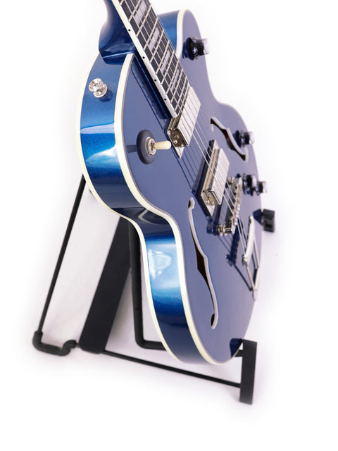 Blue Epiphone UpTown Kat ES guitar elegantly positioned on a stand with a simple white background.