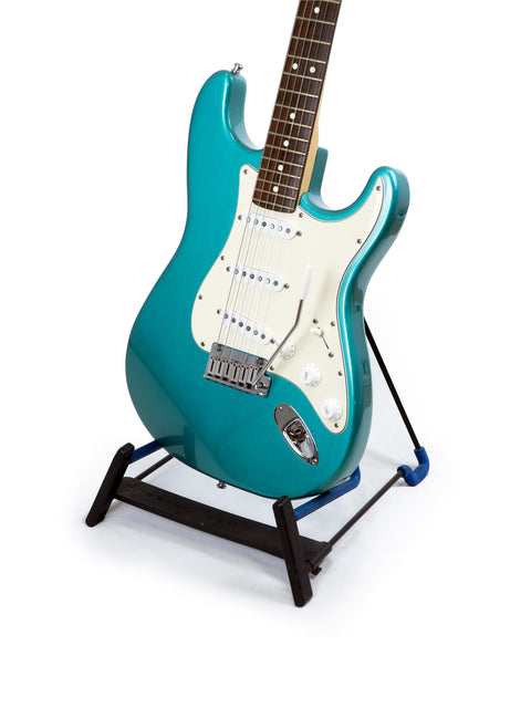 Blue electric guitar on a stand, featuring the Fender 40th Anniversary American Standard Stratocaster from 1994.