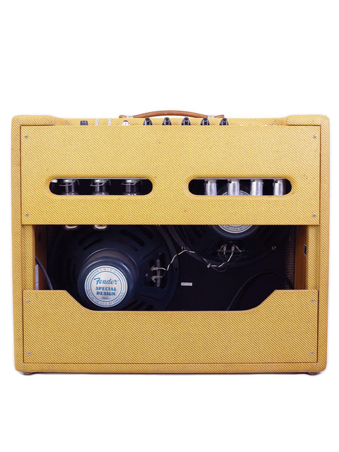 Bright yellow 1957 Fender Twin Reissue Amp with dual speakers and a microphone, ideal for live performances and practice.