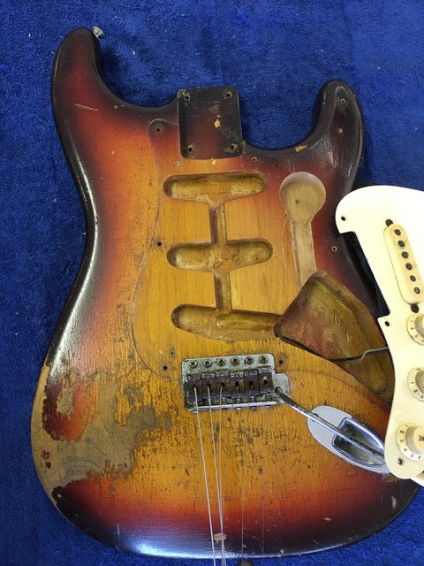 Broken neck and bridge on a vintage 1958 Fender Stratocaster, capturing the essence of a classic guitar's wear.