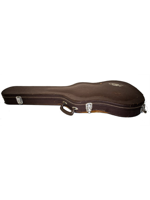 Brown guitar case on a white backdrop, featuring the vintage Washburn Mirage Deluxe made in Japan, 1984.