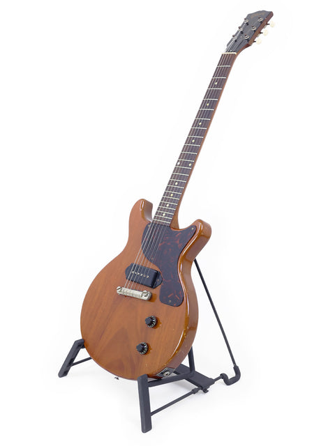 Classic 1959 Gibson Les Paul Jr guitar resting on a stand, set against a white background.