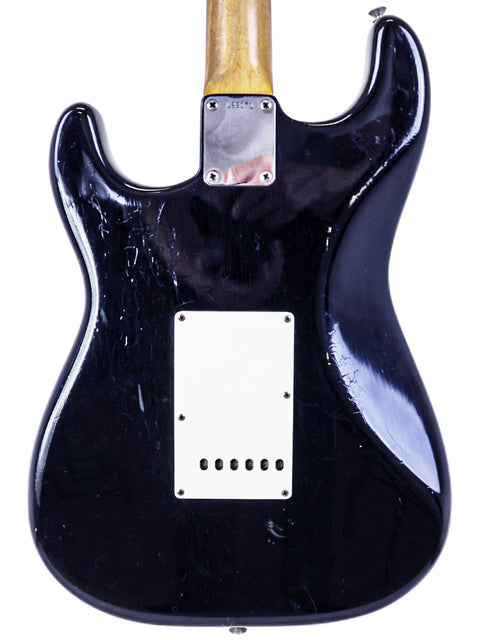 Classic 1963 Fender L-Series Stratocaster in black, with a wooden body and a stylish black pickguard.