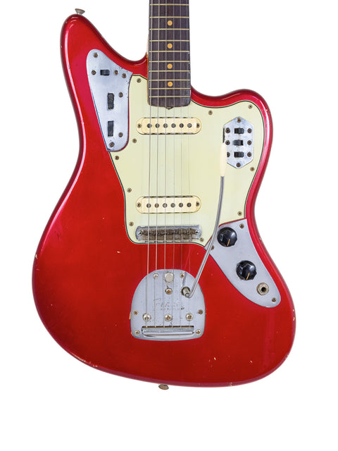Classic 1964 Fender Jaguar guitar in Candy Apple Red with a white pickup, representing vintage style and musical heritage.