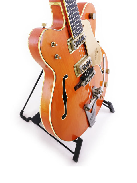 Classic 1964 Gretsch 6120 Chet Atkins guitar on a stand, ideal for musicians seeking timeless style and quality.