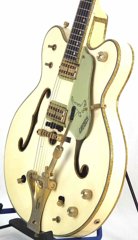 Classic 1968 Gretsch 6136 White Falcon guitar featuring gold hardware, showcased on a stand, ideal for music enthusiasts.