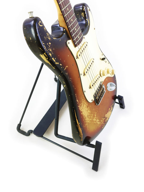 Classic 1970 Vintage Fender Stratocaster displayed on a black stand, emphasizing its iconic shape and vintage charm.
