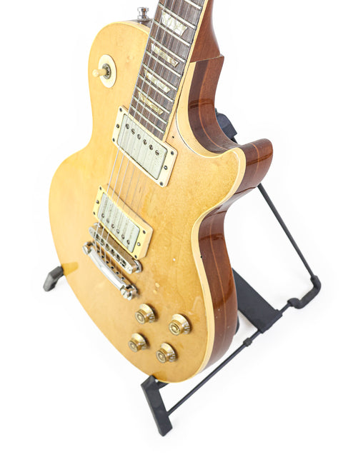 Classic 1973 Gibson Les Paul guitar, featuring a vintage deluxe refinish, known for its rich sound and iconic shape.