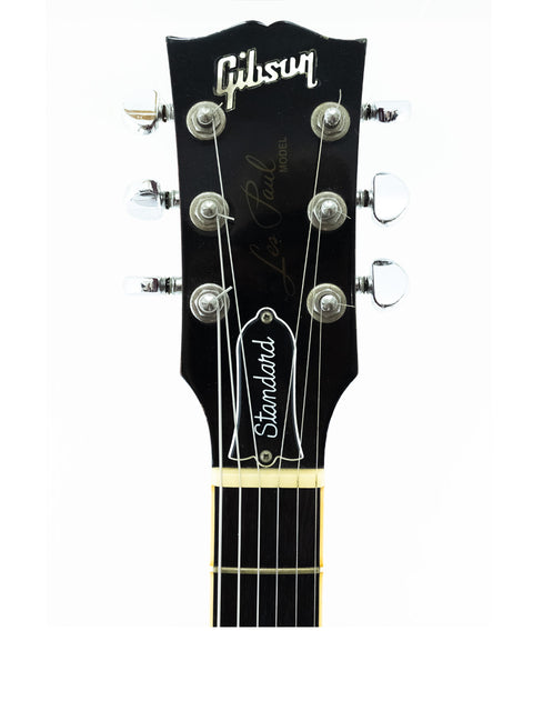 Classic 1998 Gibson Les Paul Standard electric guitar, featuring a sleek body and iconic design elements.
