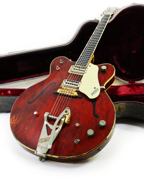 Classic red Gretsch 6122 Country Gentleman guitar from 1964, displayed in its case on the floor, ideal for music enthusiasts.
