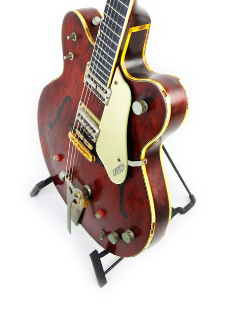 Classic red Gretsch 6122 Country Gentleman guitar with a black pick guard, a must-have for serious musicians and collectors.