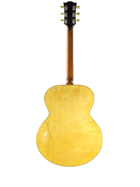 Classic yellow Gibson ES-300 guitar from 1952, featuring a wooden back and neck, embodying vintage charm.