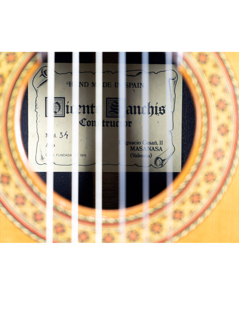 Close-up image of a guitar label stating "Vicente Sanchis Model 34 Classical – Spain 1979."