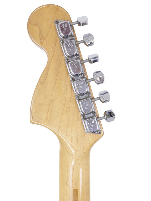 Close-up image of a vintage 1954 Fender Stratocaster guitar head, emphasizing the single pickup and iconic design features.