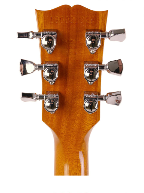 Close-up image of the headstock from a 2019 Gibson Les Paul HP acoustic guitar, emphasizing its intricate design and quality.