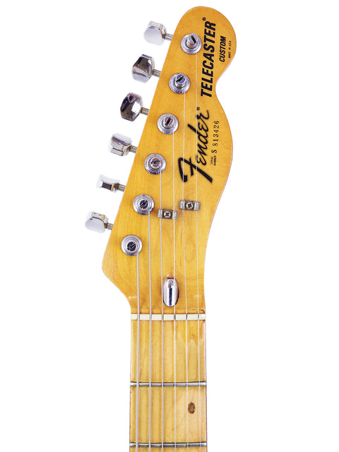 Close-up image of the neck of a 1978 Fender Telecaster Custom, emphasizing the wood grain and fretboard.