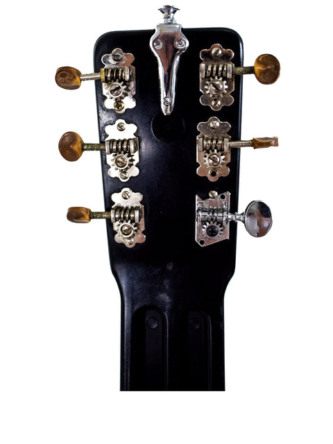  Close-up of a 1930s Rickenbacher Electro Lap Steel guitar headstock, showcasing vintage design and craftsmanship.
