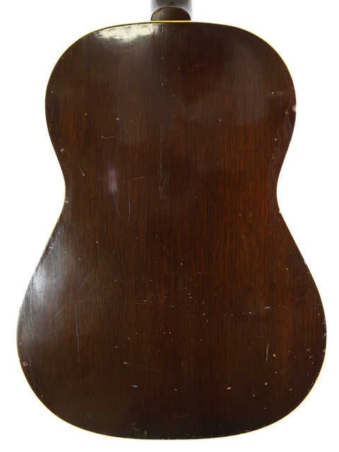 Close-up of a 1940 Gibson J-45 acoustic guitar, featuring its timeless design, with a 1954 Gibson LG-2 nearby.