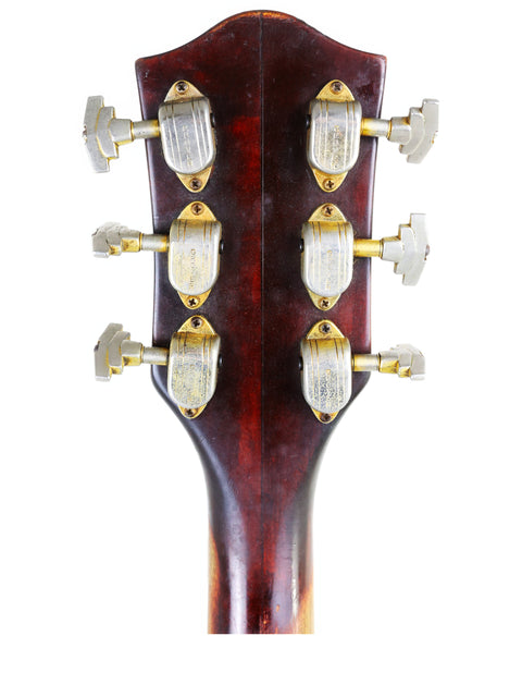 Close-up of a 1964 Gretsch 6122 Country Gentleman electric guitar headstock with four knobs, ideal for collectors and musicians.