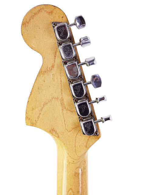 Close-up of a 1968 Fender Stratocaster headstock, showcasing a single pickup and the iconic vintage design.
