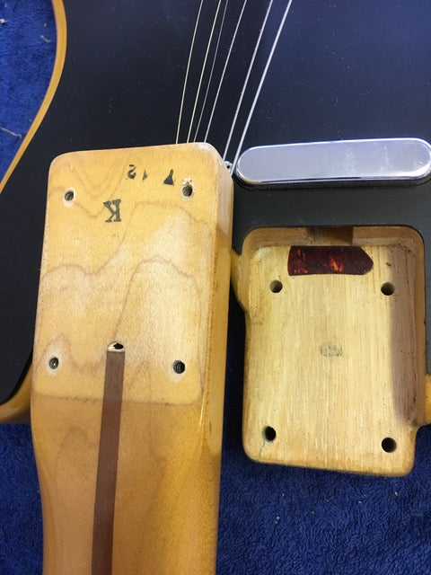 Close-up of a 1984 Fender Squier JV Telecaster, highlighting its wooden bridge and metal plate, a blend of vintage and quality.