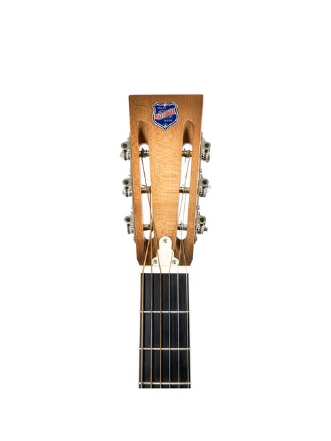 Close-up of a 2001 National Resophonic Style N Resonator guitar showcasing a blue and white logo on its neck.
