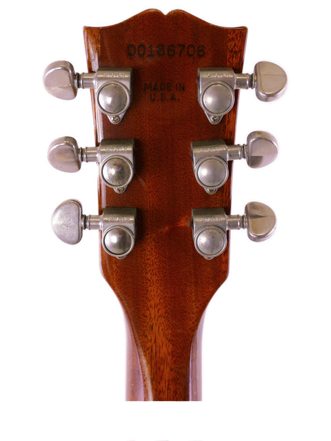 Close-up of a 2006 Gibson ES-335 Nashville headstock, showcasing four tuning knobs for acoustic guitar tuning.