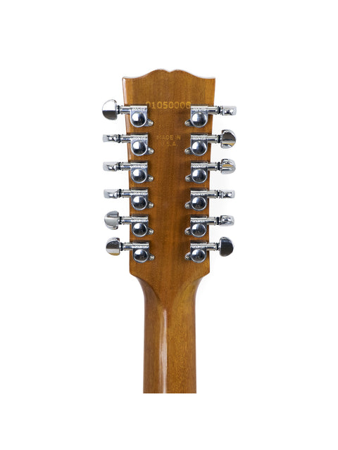 Close-up of a Gibson J-185-12 String acoustic guitar neck on a white background, highlighting its craftsmanship from 2000.
