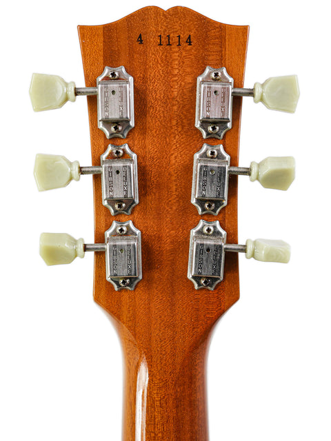 Close-up of a Gibson Les Paul LPR-4 1954 Reissue headstock showcasing four knobs for tone and volume control.