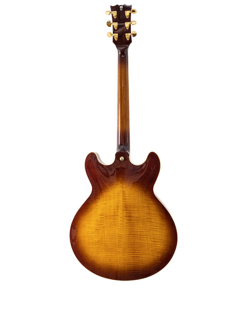Close-up of a Gibson guitar featuring a vibrant sunburst finish, highlighting its classic style and elegance.