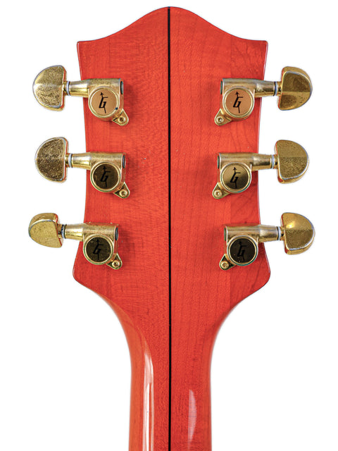 Close-up of a Gretsch 6120DE Duane Eddy Signature electric guitar headstock, showcasing its unique design and craftsmanship.