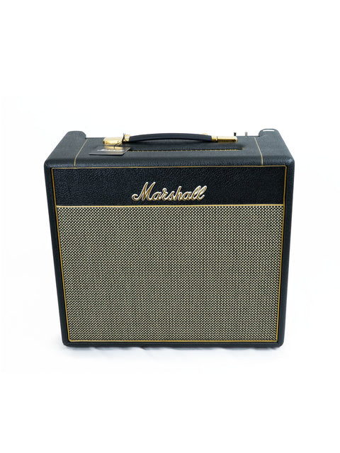 Close-up of a Marshall MXR 100W tube amplifier, highlighting its vintage aesthetics and robust build, perfect for studio use.